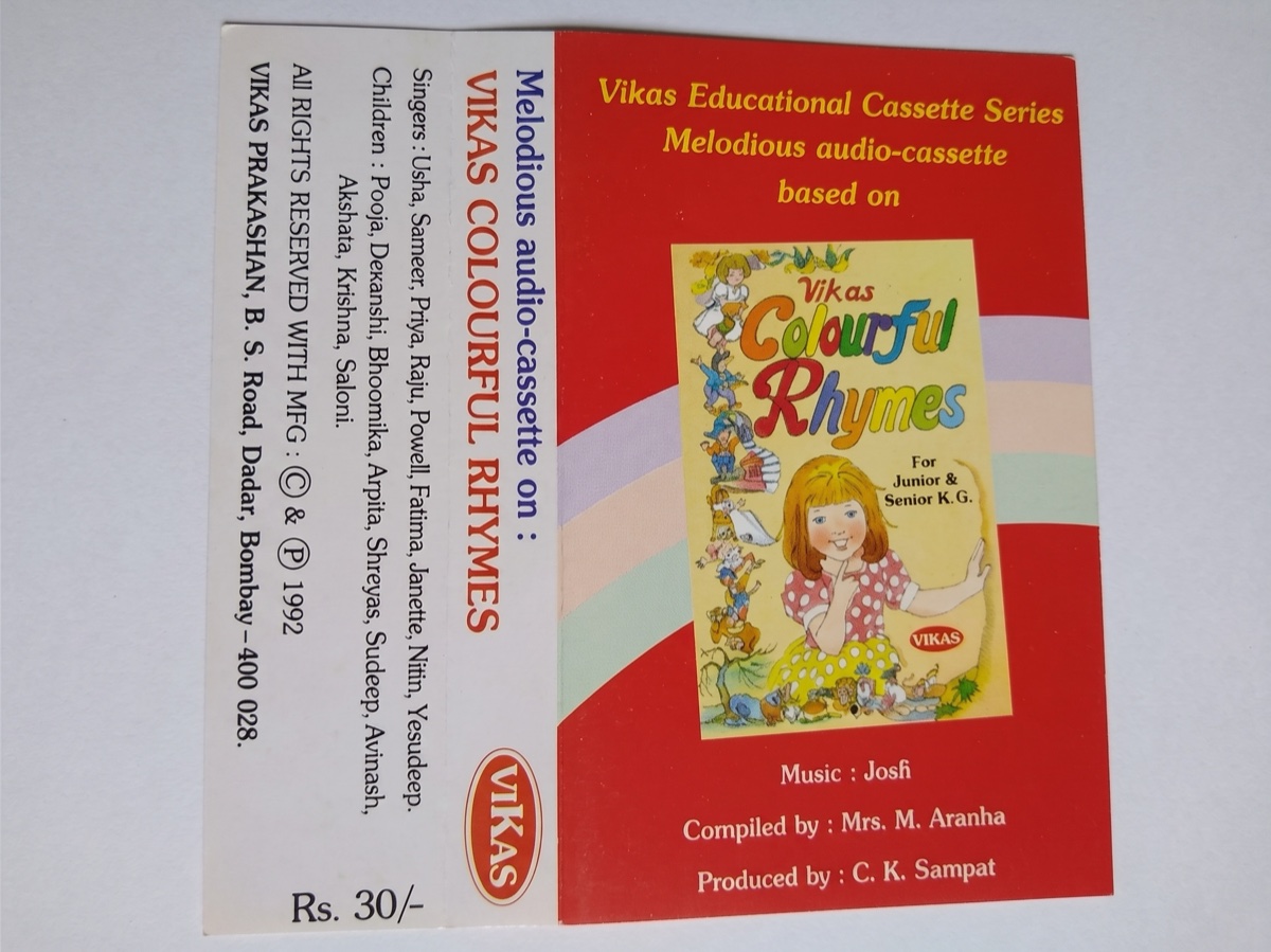 Vikas Colourful Rhymes (1992). The children's-singers list names "Yesudeep"; the music is credited to "Josfi" — my father. The cassette later surfaced on Amazon with his credit intact — no longer for sale, but still on the record.